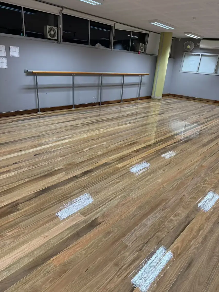 Refinished floorboards in a Freshwater Senior Campus room with windows and built-in storage