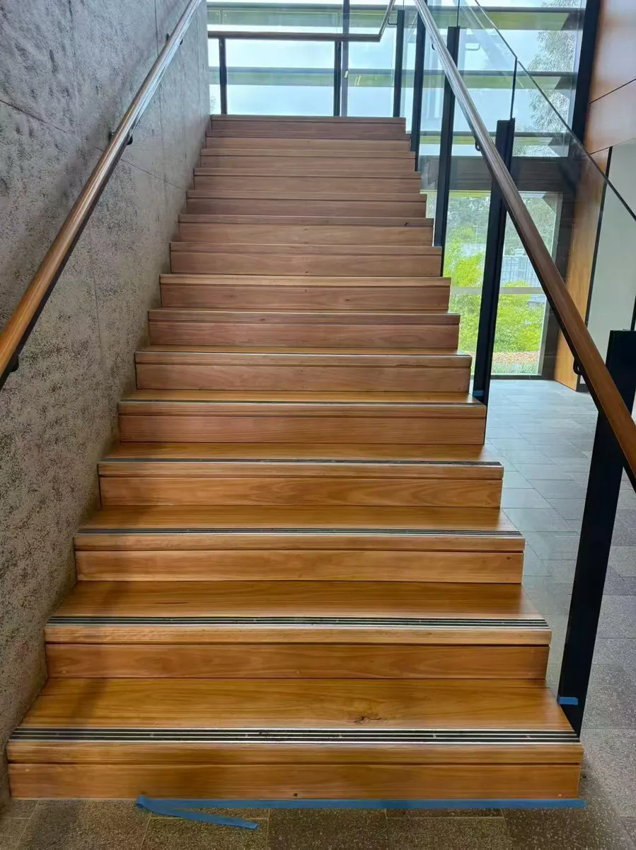 Timber staircase viewed from below, showing the refreshed stair treads at Tallawong Metro